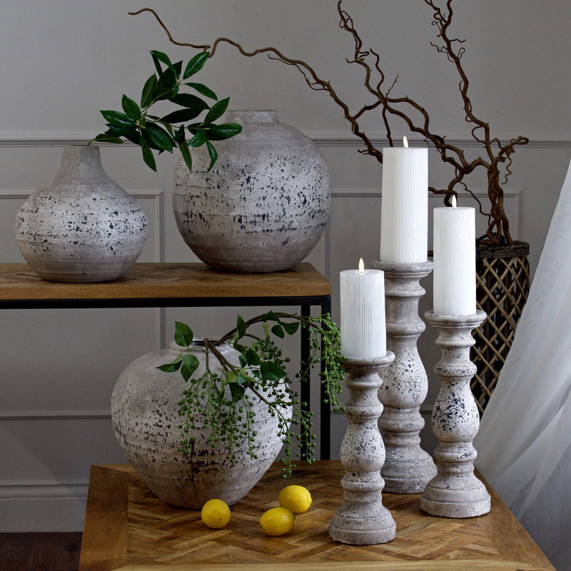 Stone-effect candle holders with LED candles, shown with smaller sizes sold separately