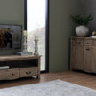 Column candle holder on a sideboard in a living room