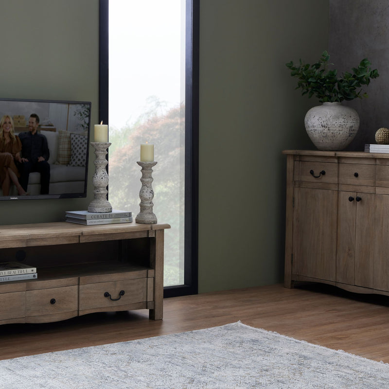 Column candle holder on a sideboard in a living room