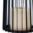 Close-up of the candle behind the black metal bars