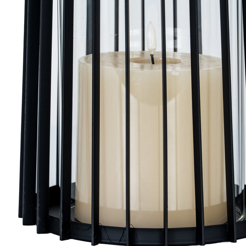 Close-up of the candle behind the black metal bars