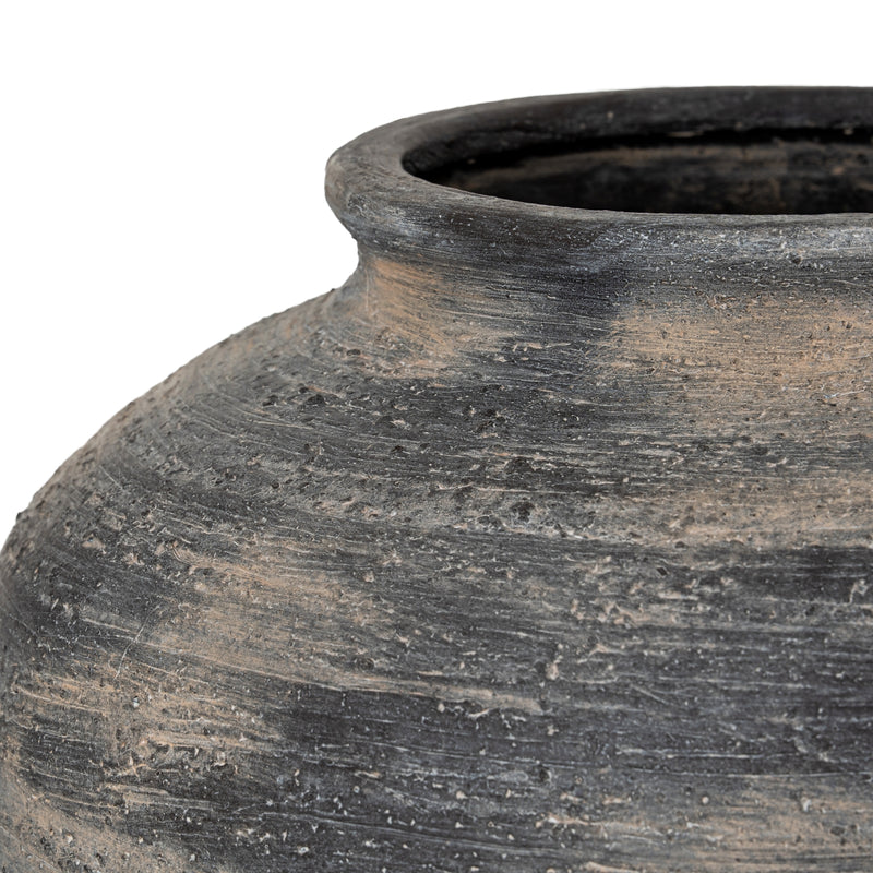 Close-up of the weathered charcoal and sand glaze