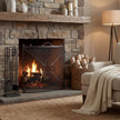 Mesh fireguard in front of a lit stone fireplace