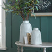 Monte vases with greenery on a table, shown with a smaller size sold separately
