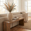 Cream textured vase with pampas grass on a wooden bench
