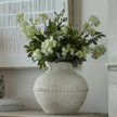 Olympia vase filled with white flowers on a sideboard