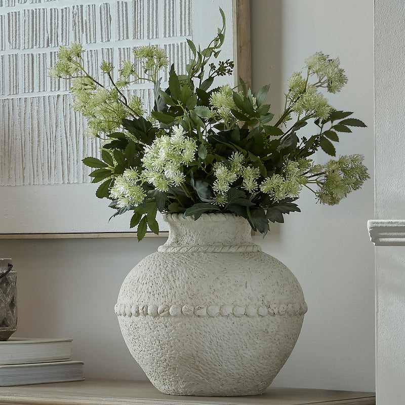 Olympia vase filled with white flowers on a sideboard
