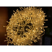 Coiled warm white LED string lights glowing on a dark background