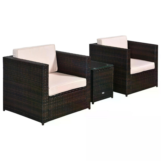 Two brown rattan armchairs with cushions and a glass-top coffee table