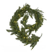 Pre-lit fir garland coiled with LED lights on