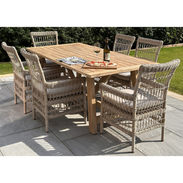 Provence acacia dining table on a patio with six woven chairs sold separately