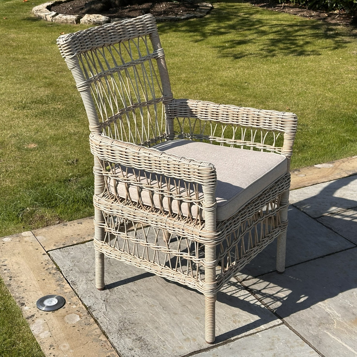Provence Rattan-Effect Garden Dining Chair with Cushion, rattan-effect garden dining chair with cushion on a lawn