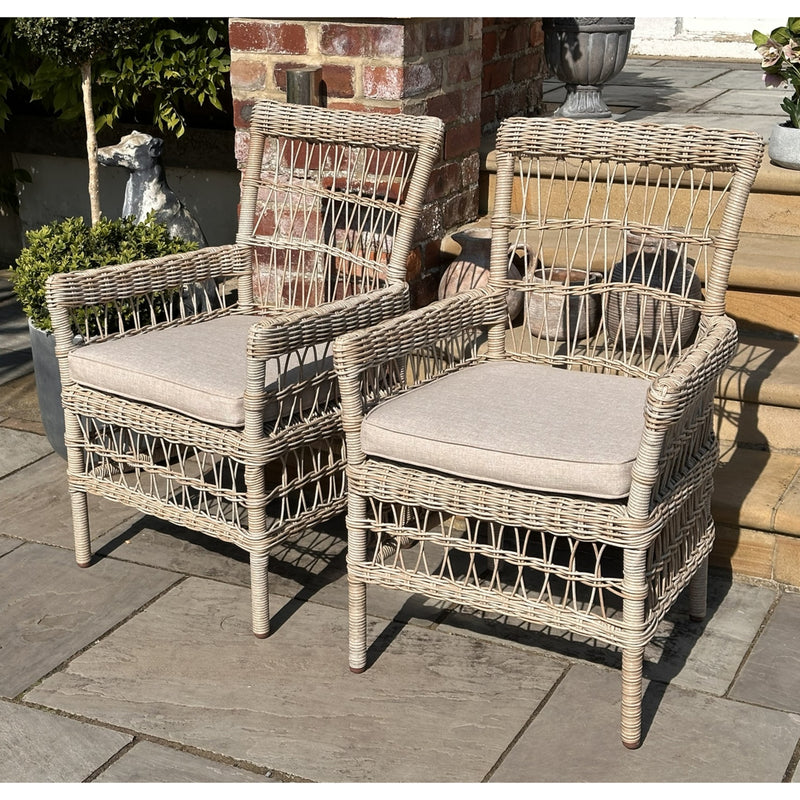 Provence Rattan-Effect Garden Dining Chair with Cushion, pair of woven garden chairs on a patio