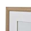 Close-up of the beaded wood-tone frame corner and white border