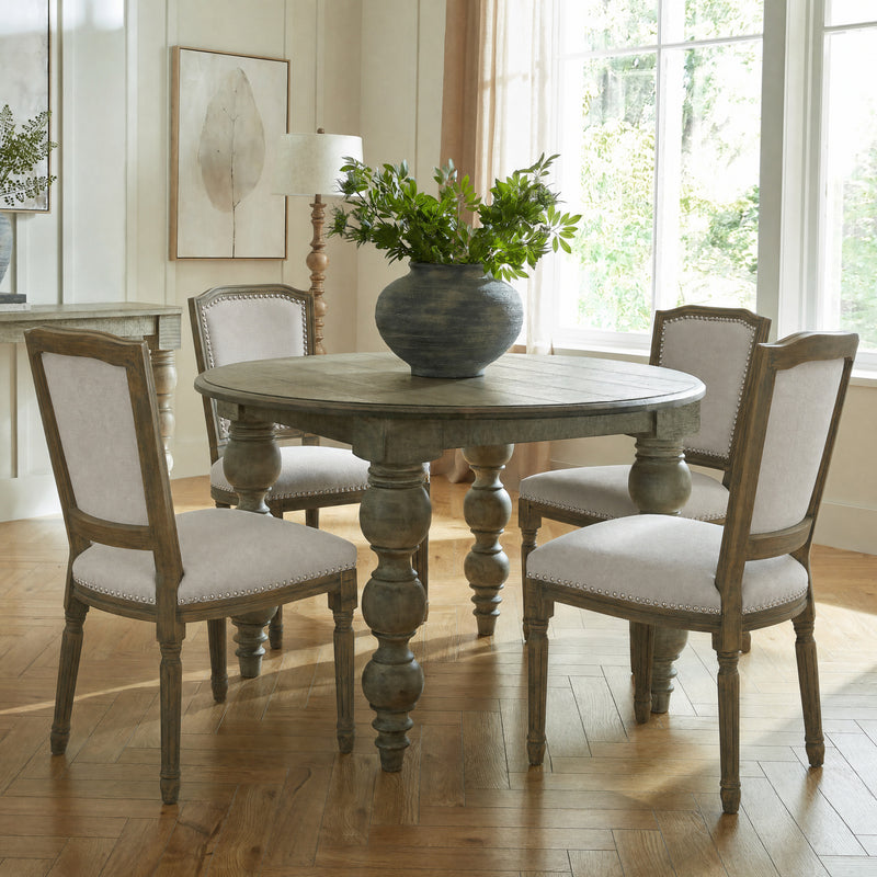 Ripley grey chairs around a round pedestal dining table
