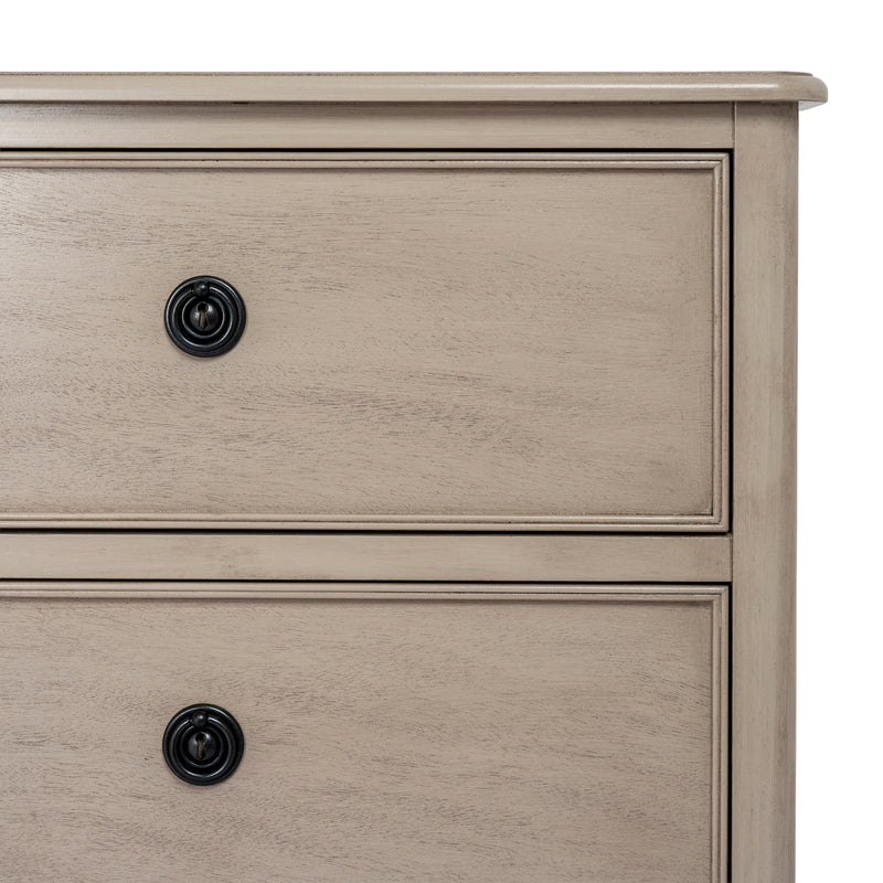 close-up of the panelled drawer fronts and black knobs