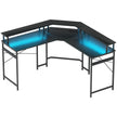 Black L-shaped corner desk with blue LED lighting and raised monitor shelf