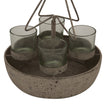 Close-up of the four glass votives in the rustic bowl
