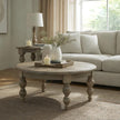 Round coffee table in a light living room with a cream sofa