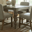 Close-up of a turned Rutland table leg between chairs