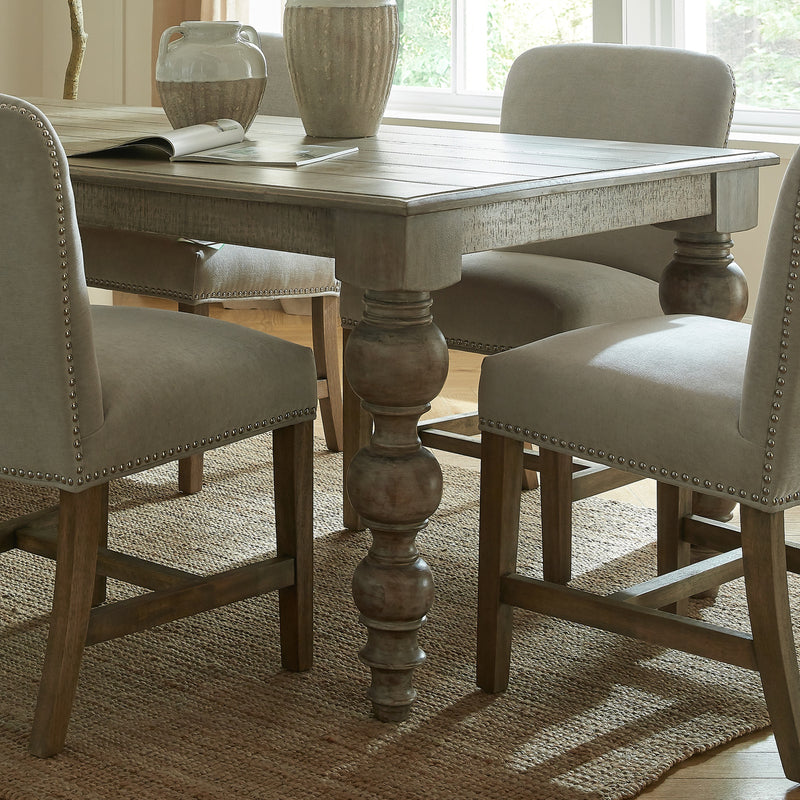 Close-up of a turned Rutland table leg between chairs