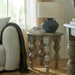 Rutland round side table beside a sofa with a lamp