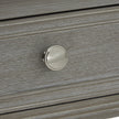 Silver-tone knob on the distressed grey drawer front