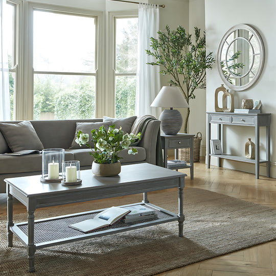 Grey console table behind a sofa in a bright living room