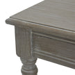 Close-up of the top edge, panelled side and turned leg