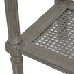 Close-up of the woven rattan shelf and turned leg
