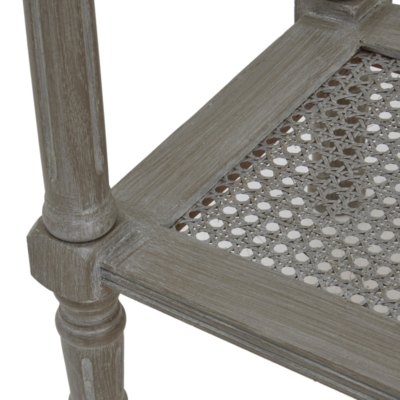 Close-up of the woven rattan shelf and turned leg