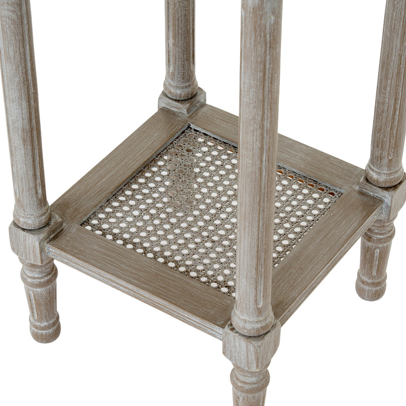 close-up of the woven rattan lower shelf and turned legs