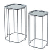 two quatrefoil mirrored side tables side by side