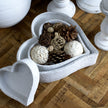 White heart dish filled with pot pourri on a wooden table