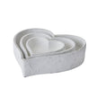 Set of three matt white ceramic heart dishes nested together