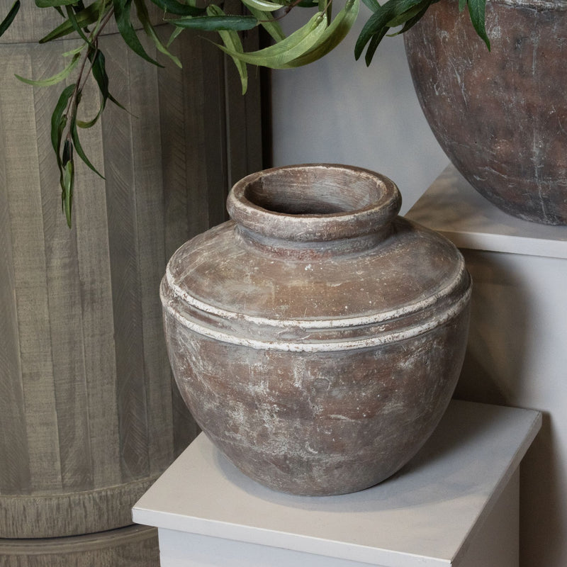 Siena brown water pot on a white plinth