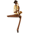 Sitting jazz saxophonist figurine in a cream jacket on white