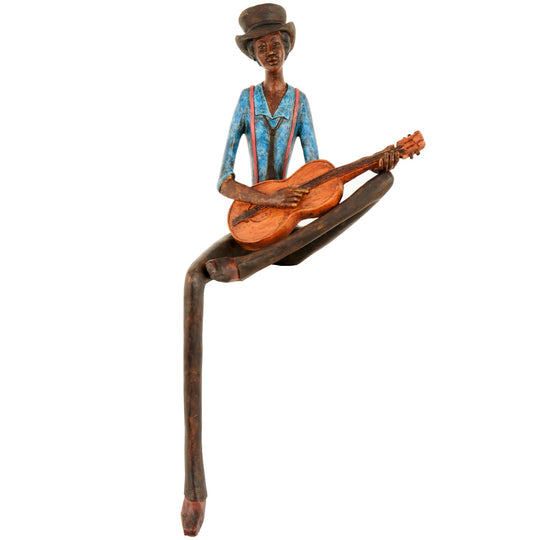 Sitting jazz string player figurine in a blue shirt on white
