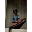 String player figurine sitting on a shelf ledge