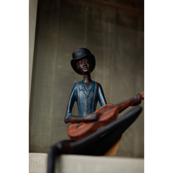 String player figurine sitting on a shelf ledge