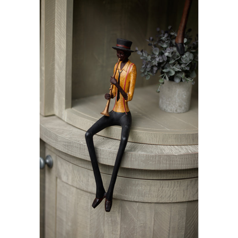 Trumpeter figurine perched on a grey cabinet