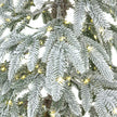 close-up of the snow-dusted branches and LED lights