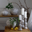Stone-effect candle holders with LED candles beside speckled vases, shown with other sizes sold separately