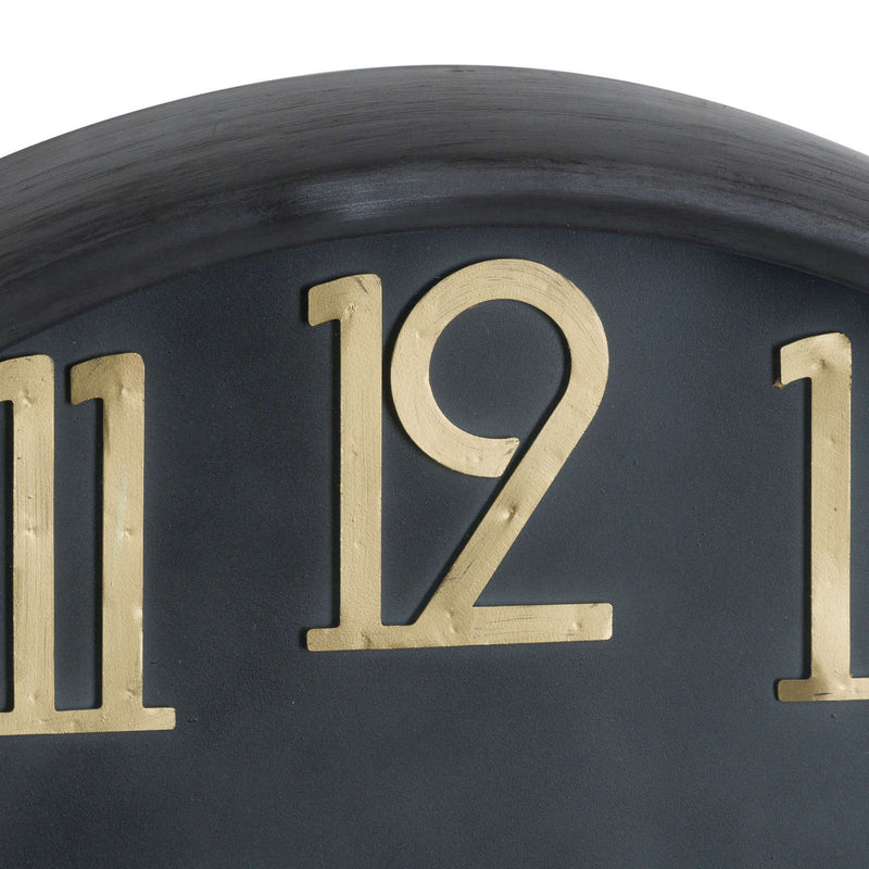 Close-up of the raised brass numerals on the black face