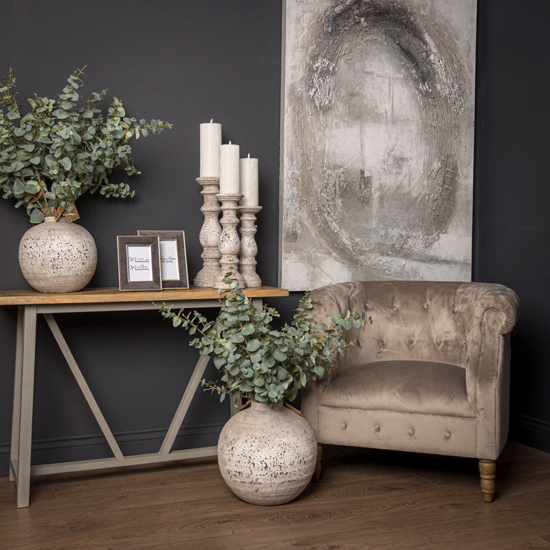 Stone-effect candle holders on a console table in a living room, other sizes sold separately