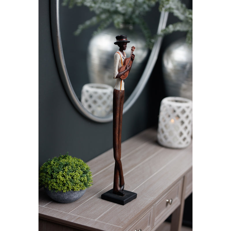 Standing violinist figurine on a console table by a mirror