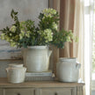 Tarn pots with flowers on a sideboard, shown with other sizes sold separately