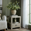 Terra urn vase with greenery on a side table
