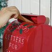 Child posting a letter to Santa