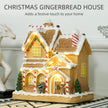 Gingerbread house with snowy roof and festive details